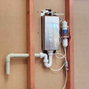 The back side of the In-wall Bottle Filler, showing plumbing and electrical connections.